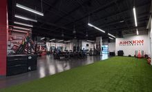 Athlete being coached about form while deadlifting at Junxion Performance