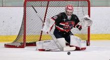 A young goalie making a save at the Hockey Etcetera Coast to Coast showdown