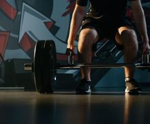 Athlete being coached about form while deadlifting at Junxion Performance