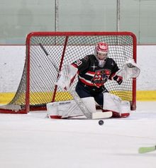 A young goalie making a save at the Hockey Etcetera Coast to Coast showdown