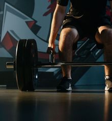 Athlete being coached about form while deadlifting at Junxion Performance