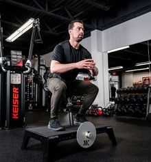 Marc Giroux using squat machine inside Junxion Performance gym