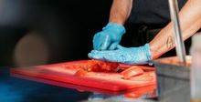 Chef at Bistro 54 chopping tomatoes on a cutting board