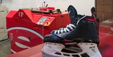 A pair of hockey skates on a counter at Hockey Etcetera's pro shop for sharpening