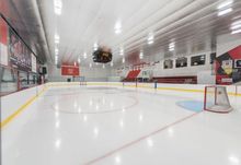 Ice level view of Hockey Etcetera's second ice surface with seating for fans on the right