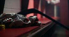 Decorative shot of a Hockey Etcetera jersey and hockey stick lieing on the dressing room bench