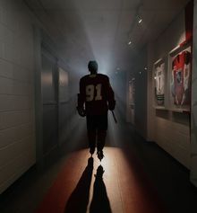 Player walking down the Hockey Etcetera hallway with dramatic lighting