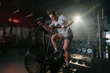 Woman biking on an assault bike in the Junxion gym