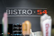 Bistro 54 signage/logo with blurred beer taps in the foreground
