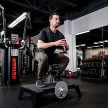 Marc Giroux using squat machine inside Junxion Performance gym